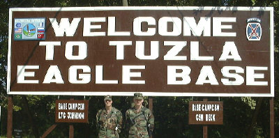 LTC Johnson and CSM Beck in front of Tuzla Base camp sign